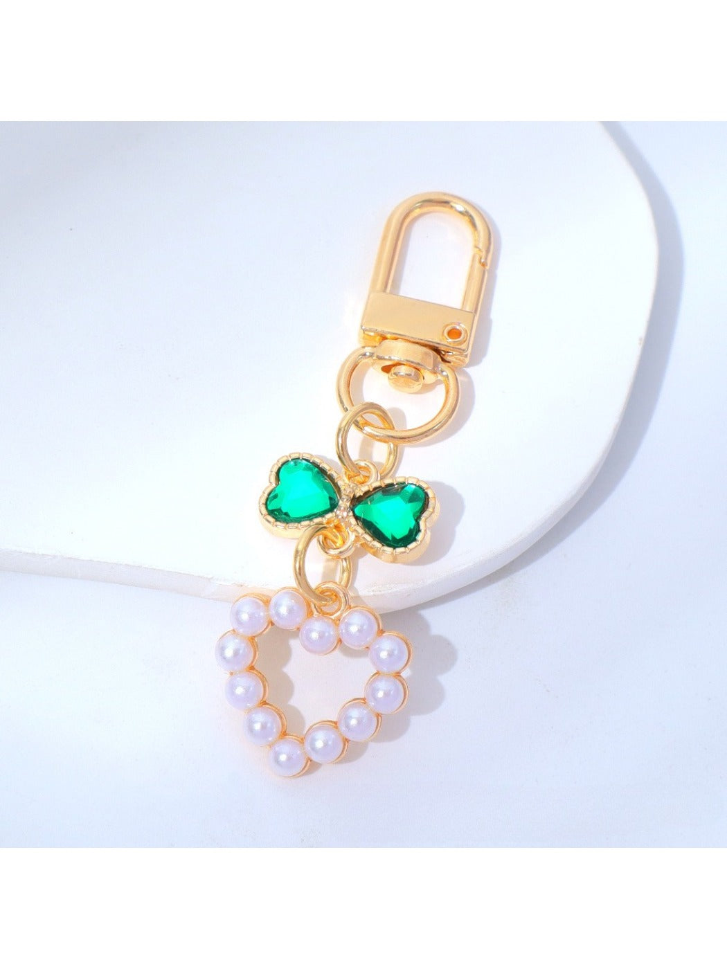 Beaded heart keychain lying flat with a shadow on a light surface