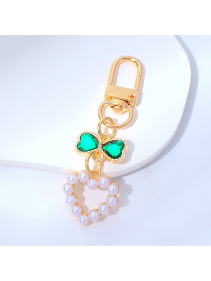 Beaded heart keychain lying flat with a shadow on a light surface