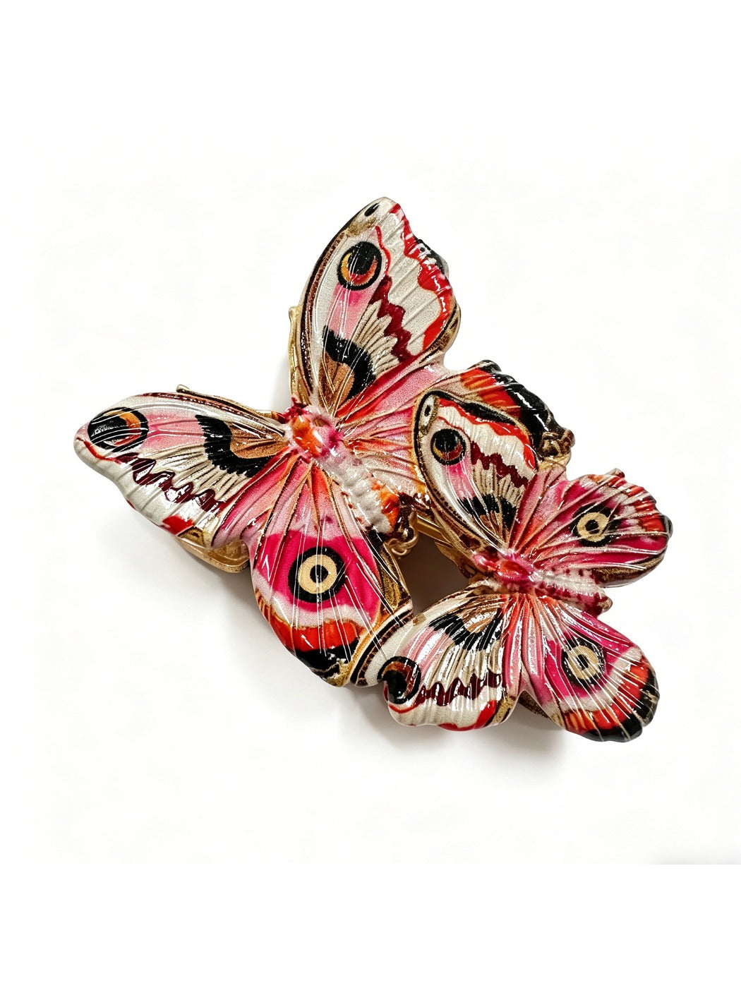 Red butterfly hair clip held in hand demonstrating lightweight and size