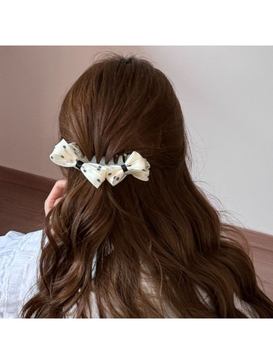 Side view of Beau polka dot bow banana clip with curved shape
