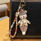 Bear charm keychain displayed on a wooden surface