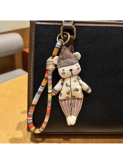 Bear charm keychain displayed on a wooden surface
