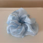 Scrunchie laid flat showing full circular shape and floral pattern