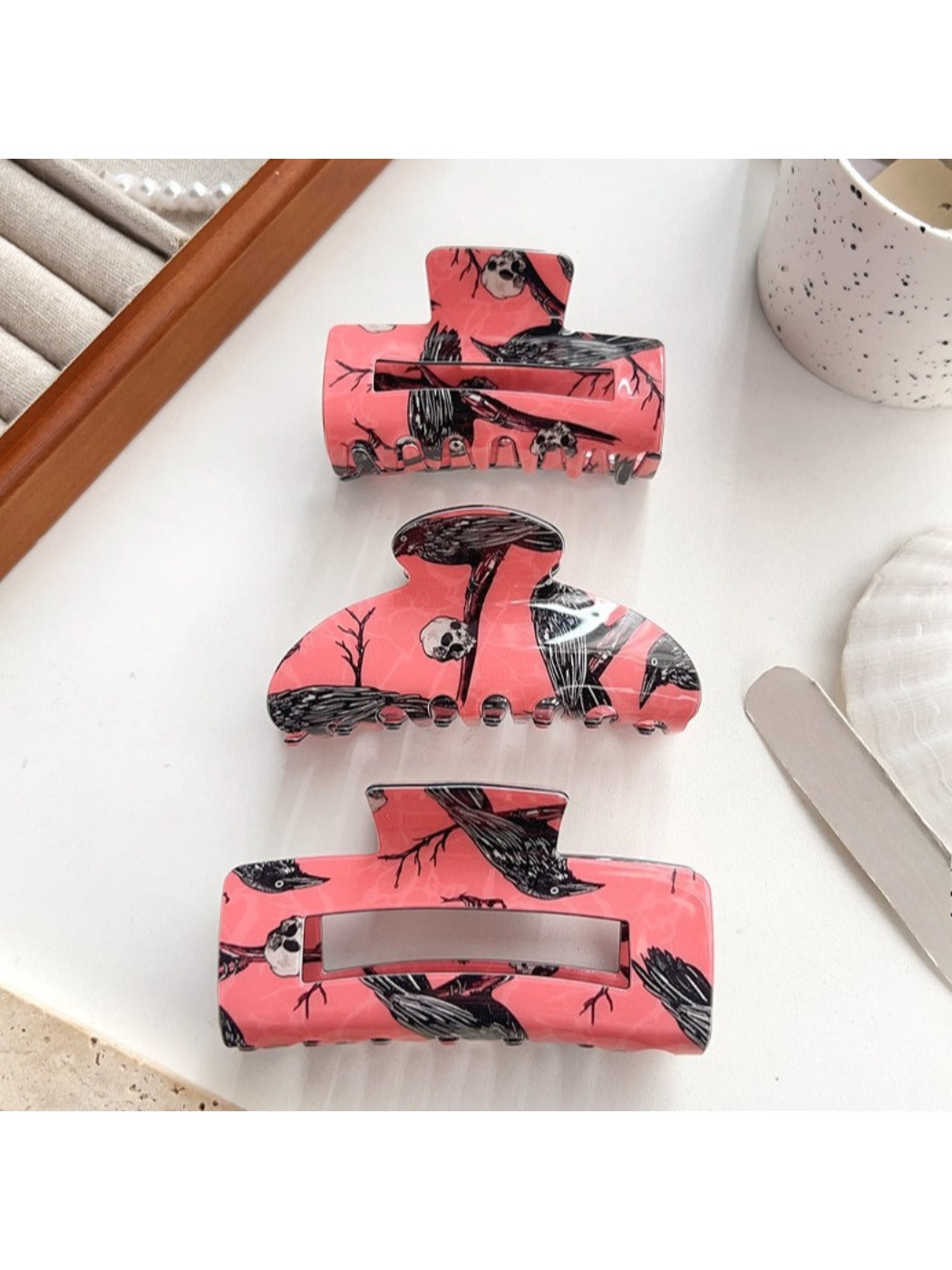 Side view of Beau crow pattern hair claw clip highlighting clip mechanism