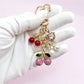 Keypus cherry charm keychain attached to a silver keyring on a white background