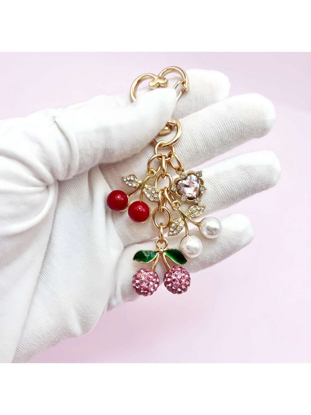 Keypus cherry charm keychain attached to a silver keyring on a white background