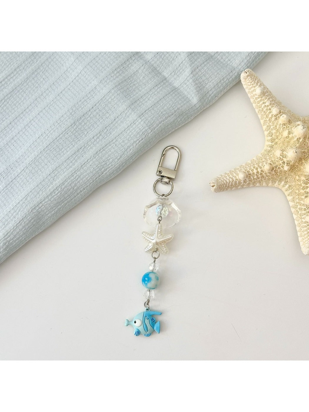 Red fish keychain close-up highlighting texture and design details