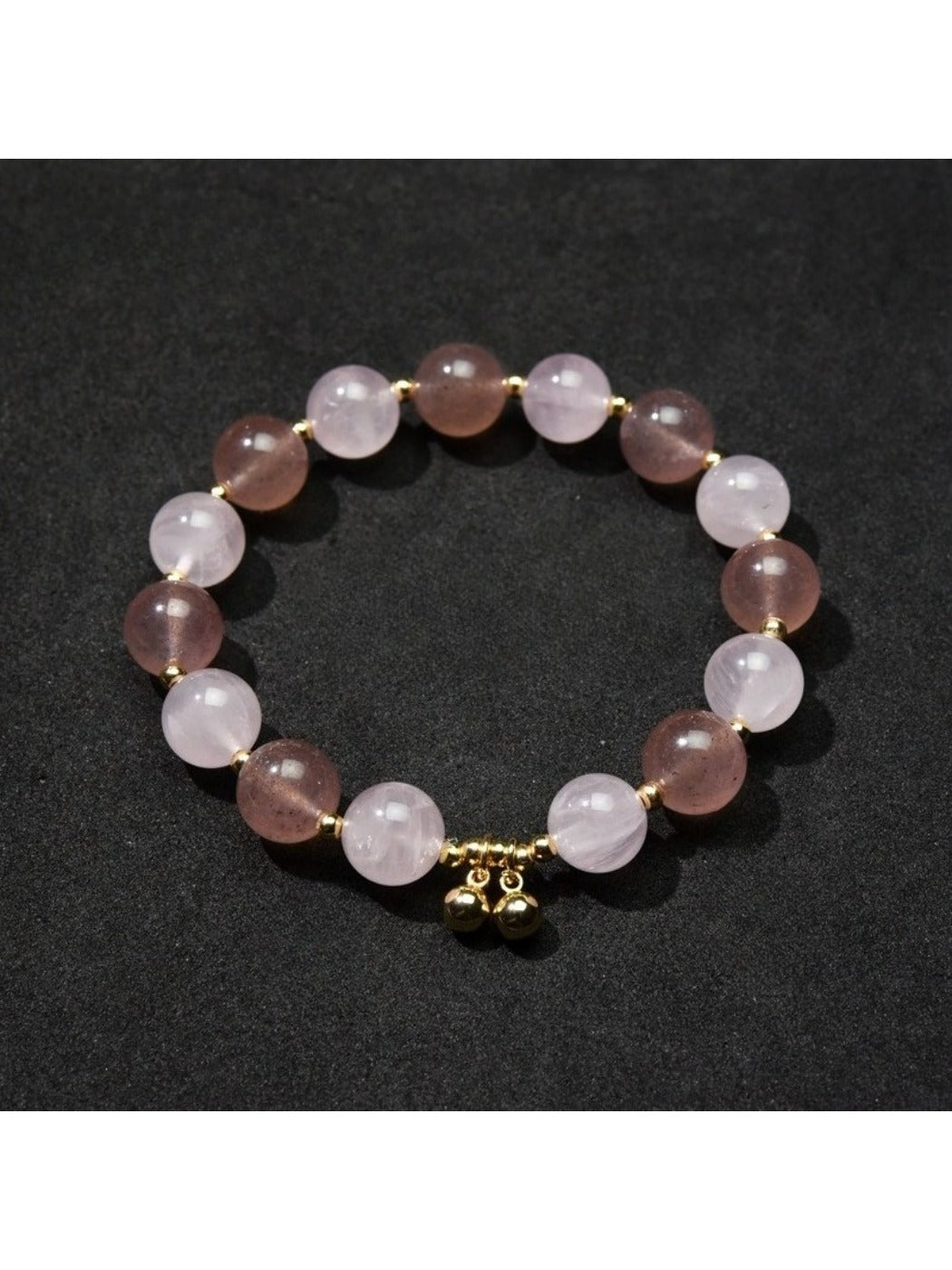 Detailed shot of heart pendant and beads on Lovra bracelet