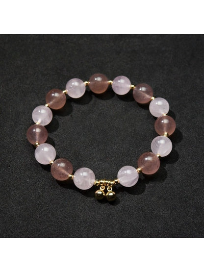 Detailed shot of heart pendant and beads on Lovra bracelet