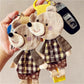Close-up of the bear keychain's patchwork fabric showing detailed stitching and texture