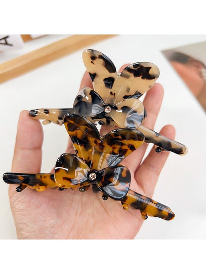 Close-up of Beau hair claw clip showing smooth matte finish and bow design