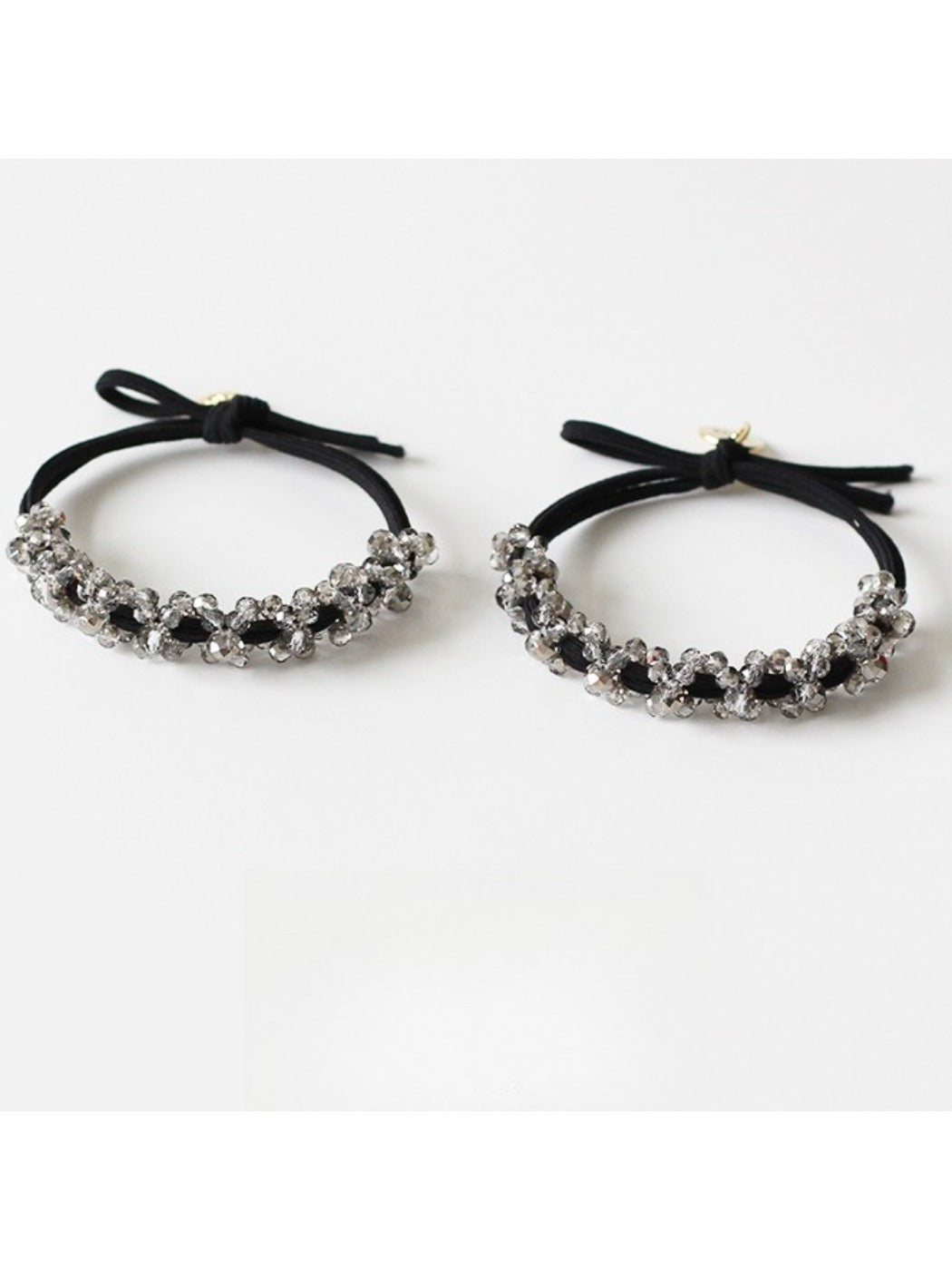 Gifty beaded hair tie worn on a wrist showing its simple and elegant design
