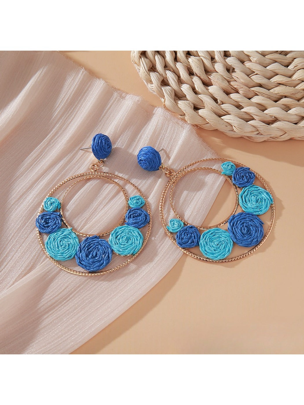 Sweet Raffia Circle Stud Earrings displayed on a wooden surface
