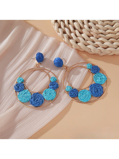 Sweet Raffia Circle Stud Earrings displayed on a wooden surface