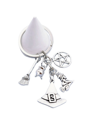Witch hat and broom keychain held in hand to show size and detail