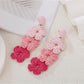 Pair of Bohemian style drop earrings with vibrant color blocks and gold hooks
