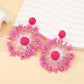 Sweet Flower Firework Shaped Earrings arranged with floral props