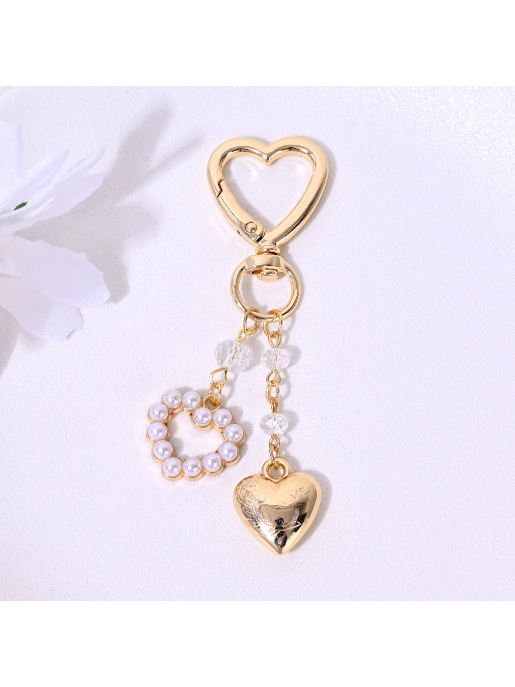 Close-up of alloy heart keychain showing detailed texture and keyring attachment