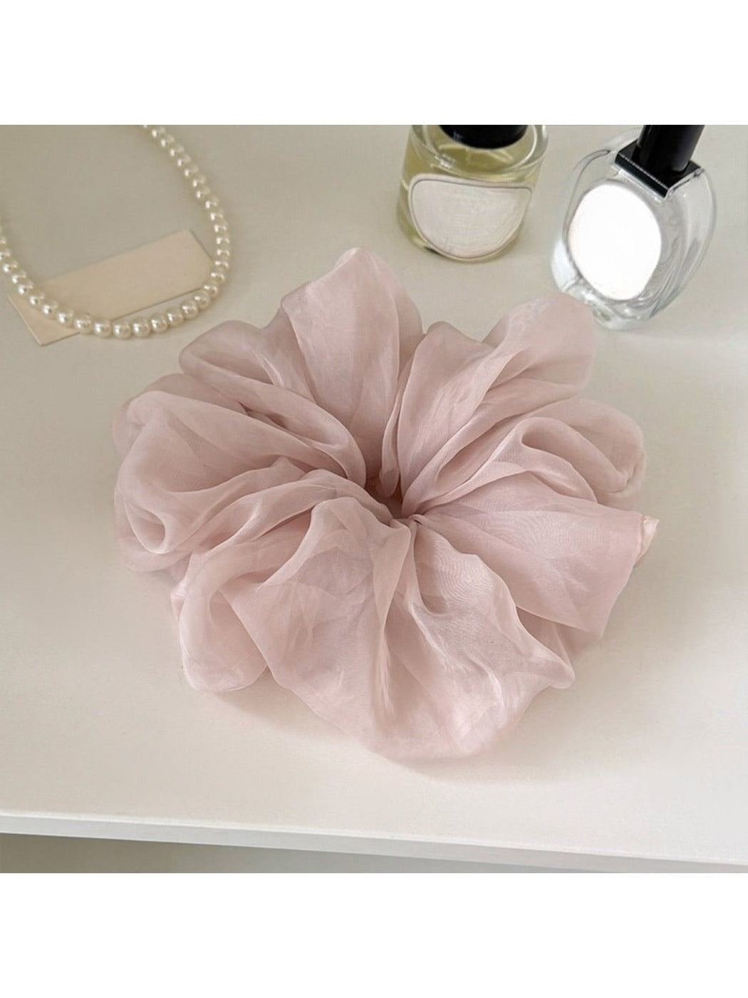 Scrunchie placed on a wooden surface emphasizing its soft material