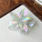 Beau flower shaped claw clip clipped onto hair showing usage example