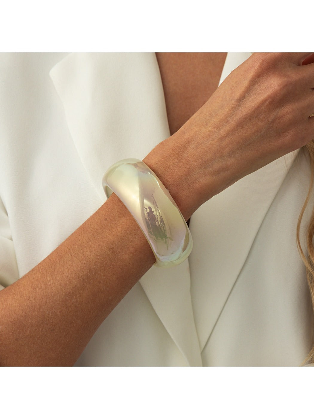 Lovra bangle bracelet displayed with other minimalist jewelry pieces