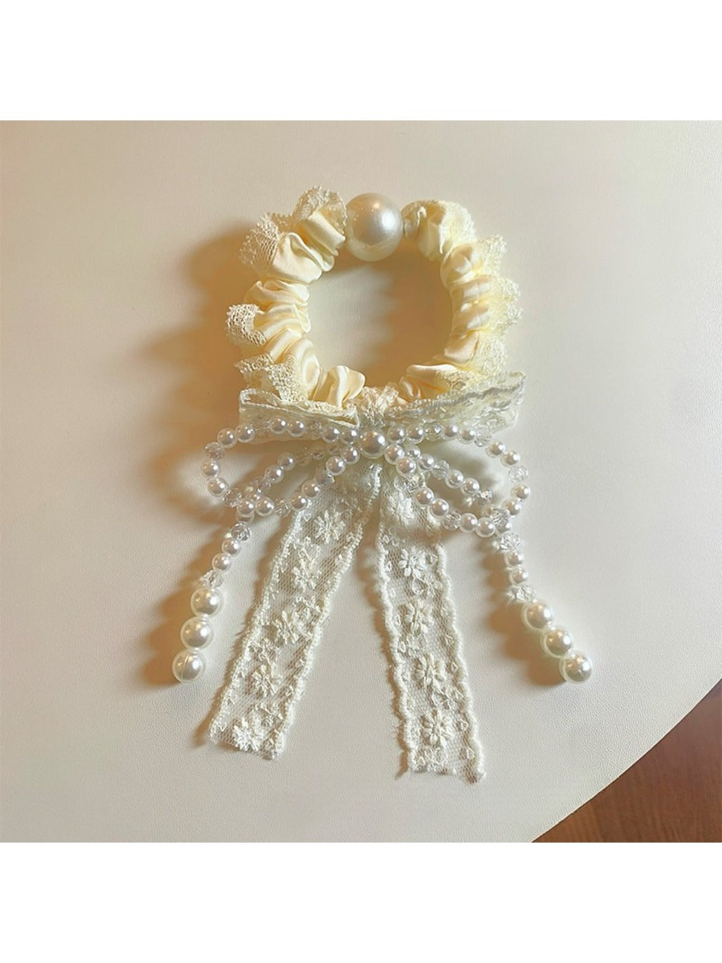 Close-up of Gifty Sweet Beaded Bow Hair Tie with pink beads on a black elastic band