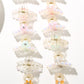 Bright multi color hair clip held in hand displaying size and shape