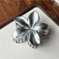 Beau flower shaped claw clip shown alongside matching accessories