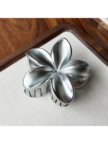 Beau flower shaped claw clip shown alongside matching accessories