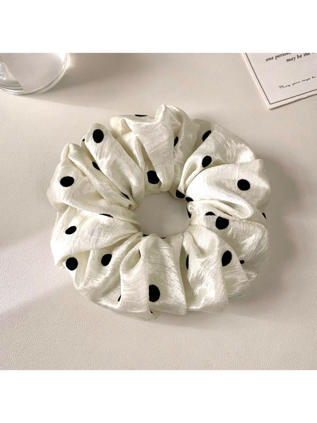Side view of Gifty minimalist satin polka dot scrunchie showing fabric texture