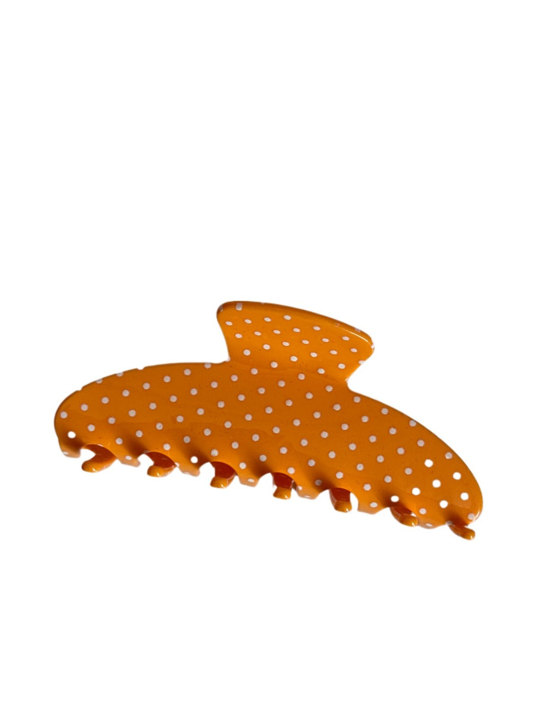 Beau hair clip placed on a wooden surface with natural lighting