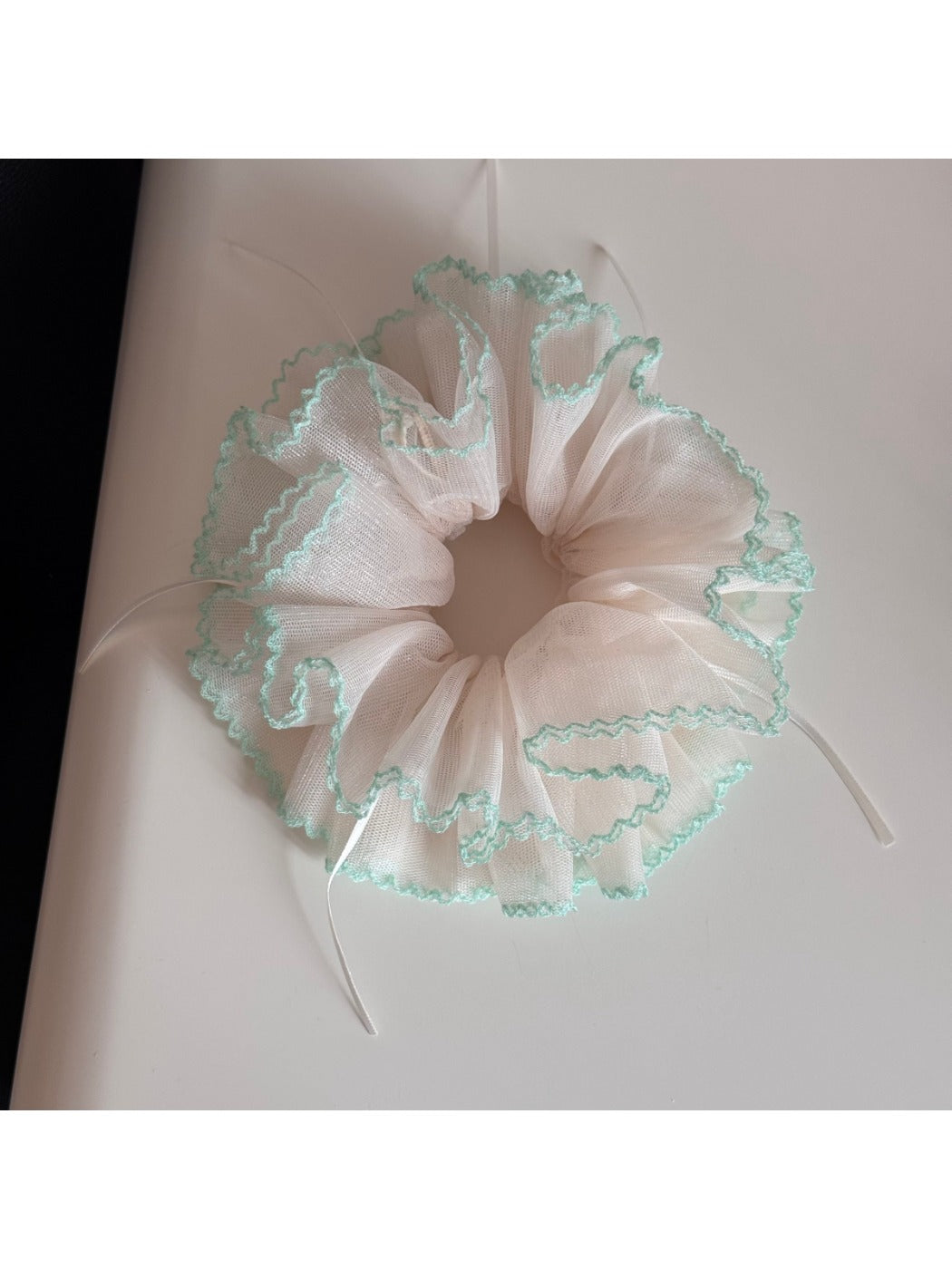 Gifty Ribbon Knot Tulle Scrunchie styled in a ponytail on a model with dark hair