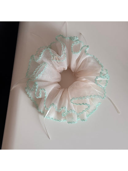 Gifty Ribbon Knot Tulle Scrunchie styled in a ponytail on a model with dark hair