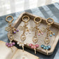 Close-up of ballerina charm showing detailed tutu and ballet shoes on keychain