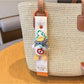 Hand holding Keypus cute duck charm keychain with a silver keyring