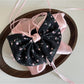 Beau Sweet Tiny Floral Bow Claw Clip angled to show clasp mechanism and bow detail