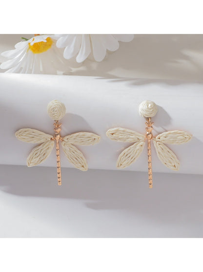 Raffia dragonfly earrings styled with casual outfit on model