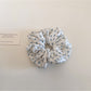 Gifty ditsy floral scrunchie stretched to show elastic band inside soft floral fabric