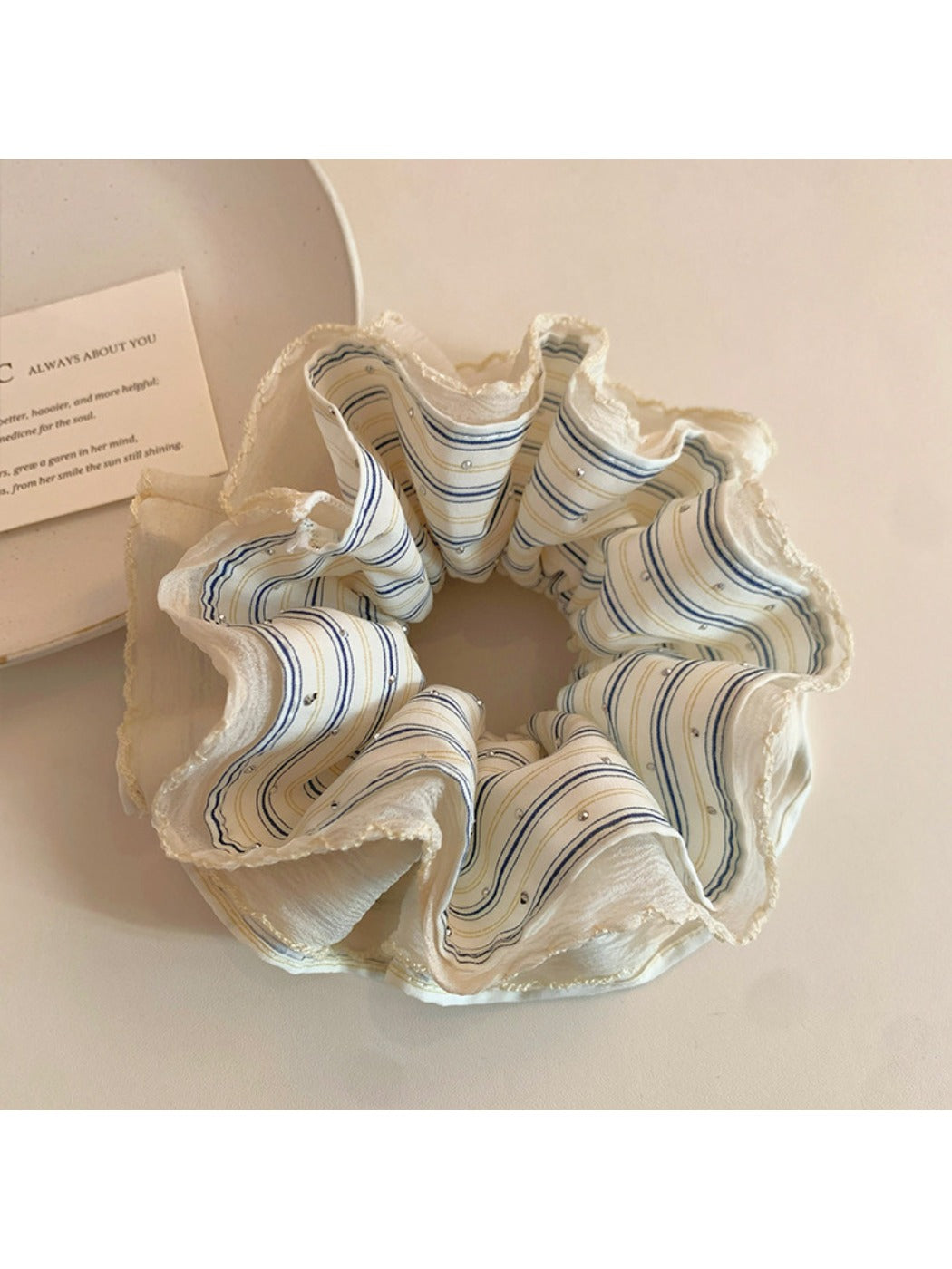 Gifty striped scrunchie styled on a ponytail showing its stretch and fabric texture