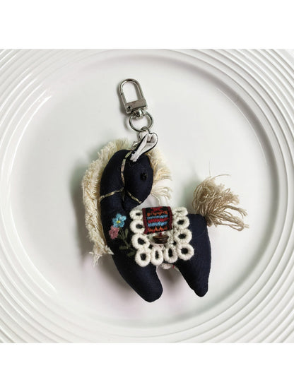 Fabric pony keychain with soft pastel colors and metal keyring on white background