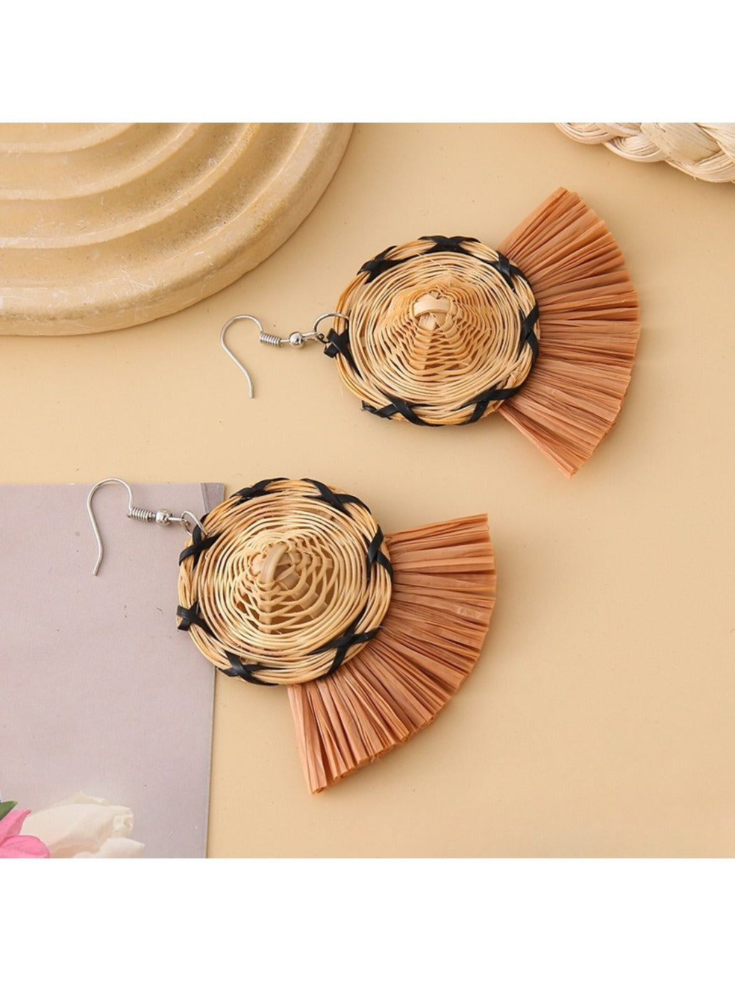 Earedge straw hat earrings worn on a model's ear