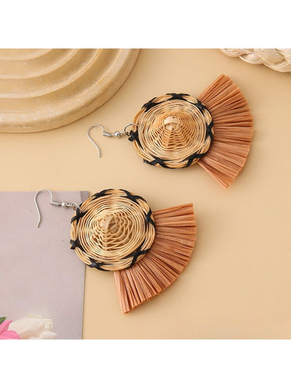 Earedge straw hat earrings worn on a model's ear
