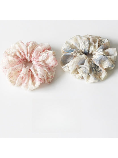 Side view of Gifty scrunchie highlighting ruched design and elastic band