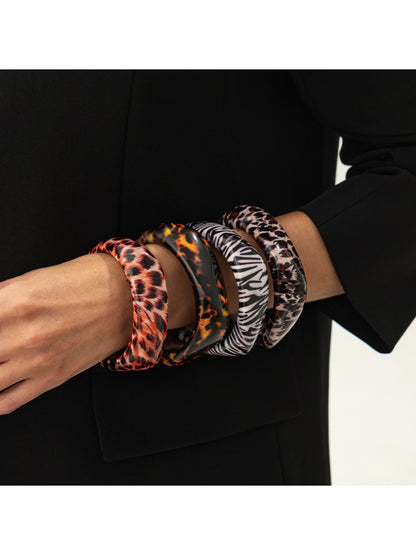 Close-up of Lovra leopard print bangle showing textured pattern and curved design
