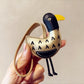 Top view of the ostrich keychain showing its rounded body and keyring