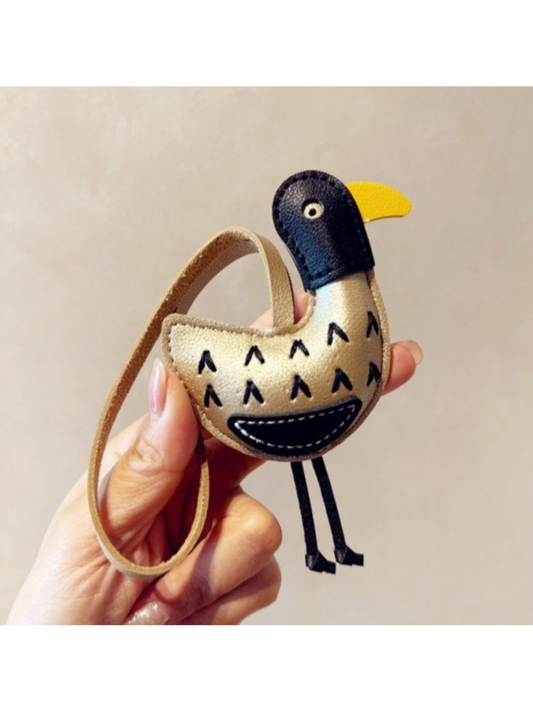 Top view of the ostrich keychain showing its rounded body and keyring