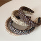 Close-up of Gifty headband showing detailed vintage floral pattern