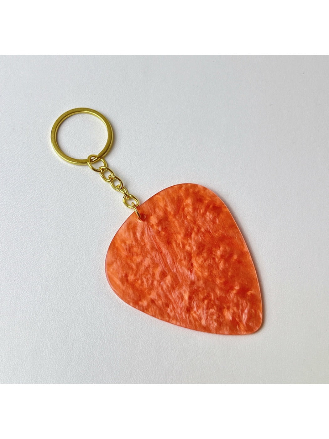 Textured teardrop charm keychain with a polished silver look on a white background