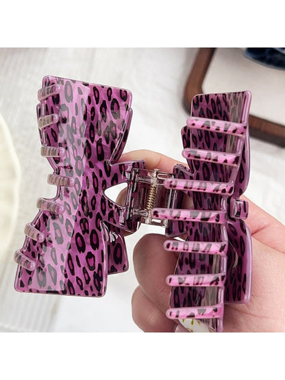 Beau leopard print claw clip holding hair in a half-up hairstyle