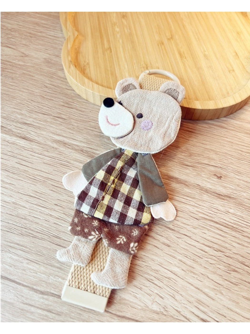 Fabric patchwork bear keychain hanging from a keyring with visible stitching and colors